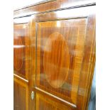 Late 19th century banded mahogany triple wardrobe compactum with ebony and boxwood stringing, the