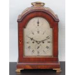 Mahogany striking bracket clock with domed top, hinged brass carry handle, the top with three