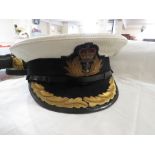 Royal Navy Officer's cap labelled Gieves, and a leather belt with strap and gilt metal buckle