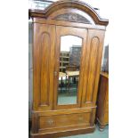 Victorian mahogany arch topped wardrobe, the single mirrored door between two moulded panels, the