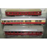 Three Marklin HO gauge tinplate dining and sleeping coaches - a double bogey sleeping coach in red