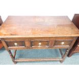 A late seventeenth or early eighteenth century oak low boy or sideboard with three drawers, on