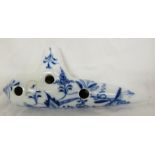 Porcelain ocarina with underglaze blue foliate decoration, stamped MEISSEN 5D, length 18cm