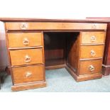 19th century oak desk with a wide and shallow top drawer, three drawers to either side with brass