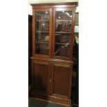 A marriage bookcase or display case, the top section in mahogany with two plain glazed doors