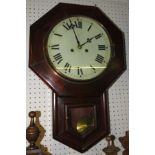 A Victoria stained pine octagonal striking eight day wall clock with lower hinged glass pendulum