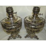 Pair of electroplated oil lamp bases extensively moulded and engraved with scrolled foliage, the