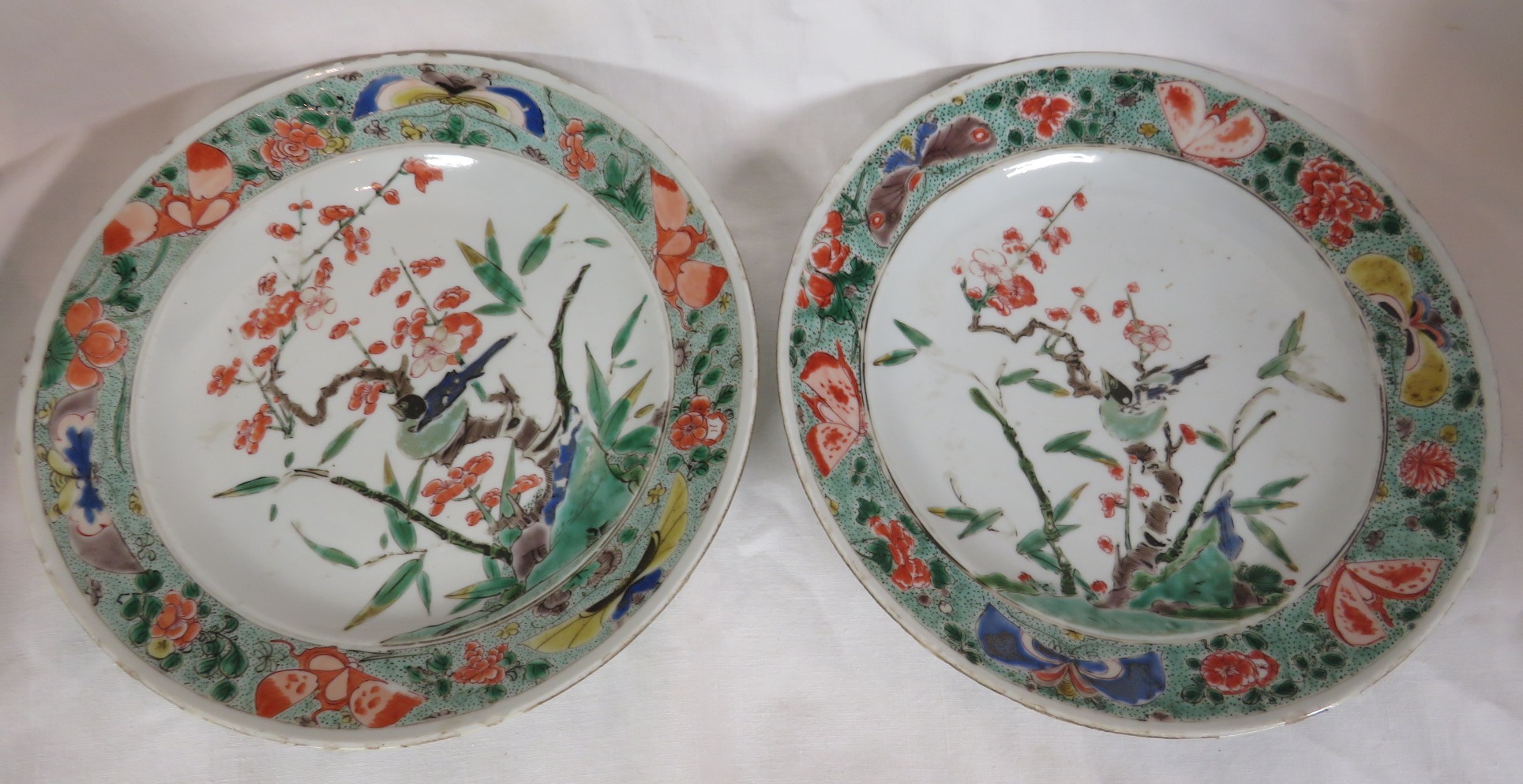 Two Chinese porcelain plates enamelled in the famille verte palette with flowering branch and