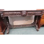 Victorian heavily carved oak hall table or side table in the Gothic manner, carved to the frieze and