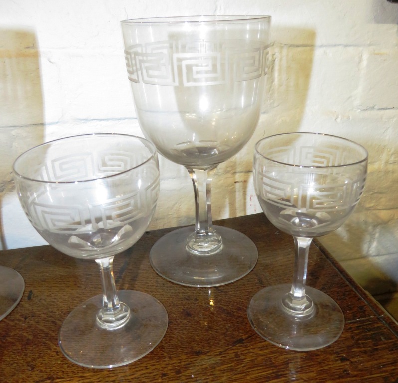 A suite of drinking glasses and a near pair of bottle shape decanters, all etched with key fret - Image 4 of 8