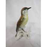 Karl Ens porcelain model of a bird with brown plumage and yellow breast perched on a branch with