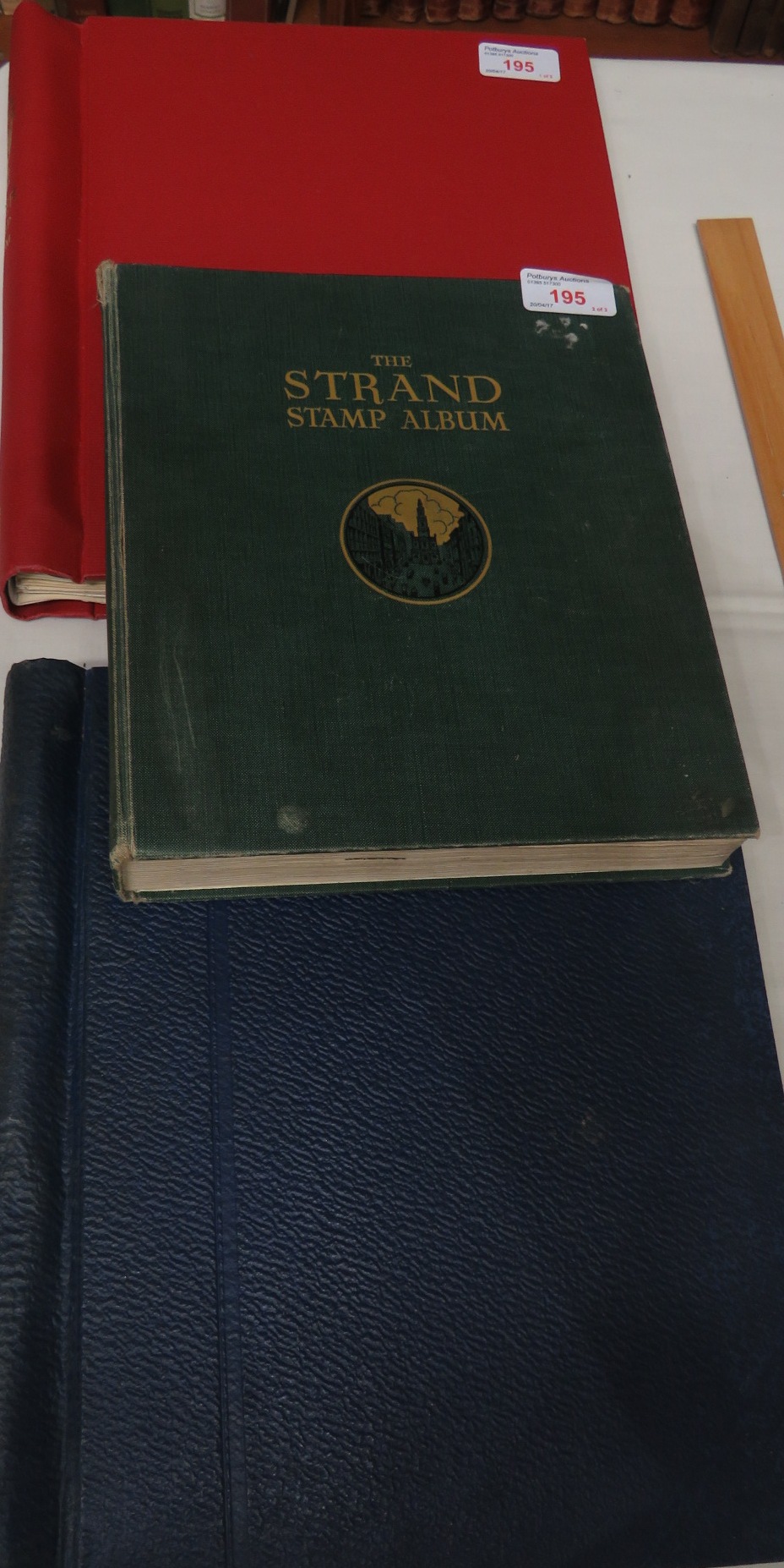 A red Tower stamp album containing early Canadian, New Zealand, Irish Free State over stamped