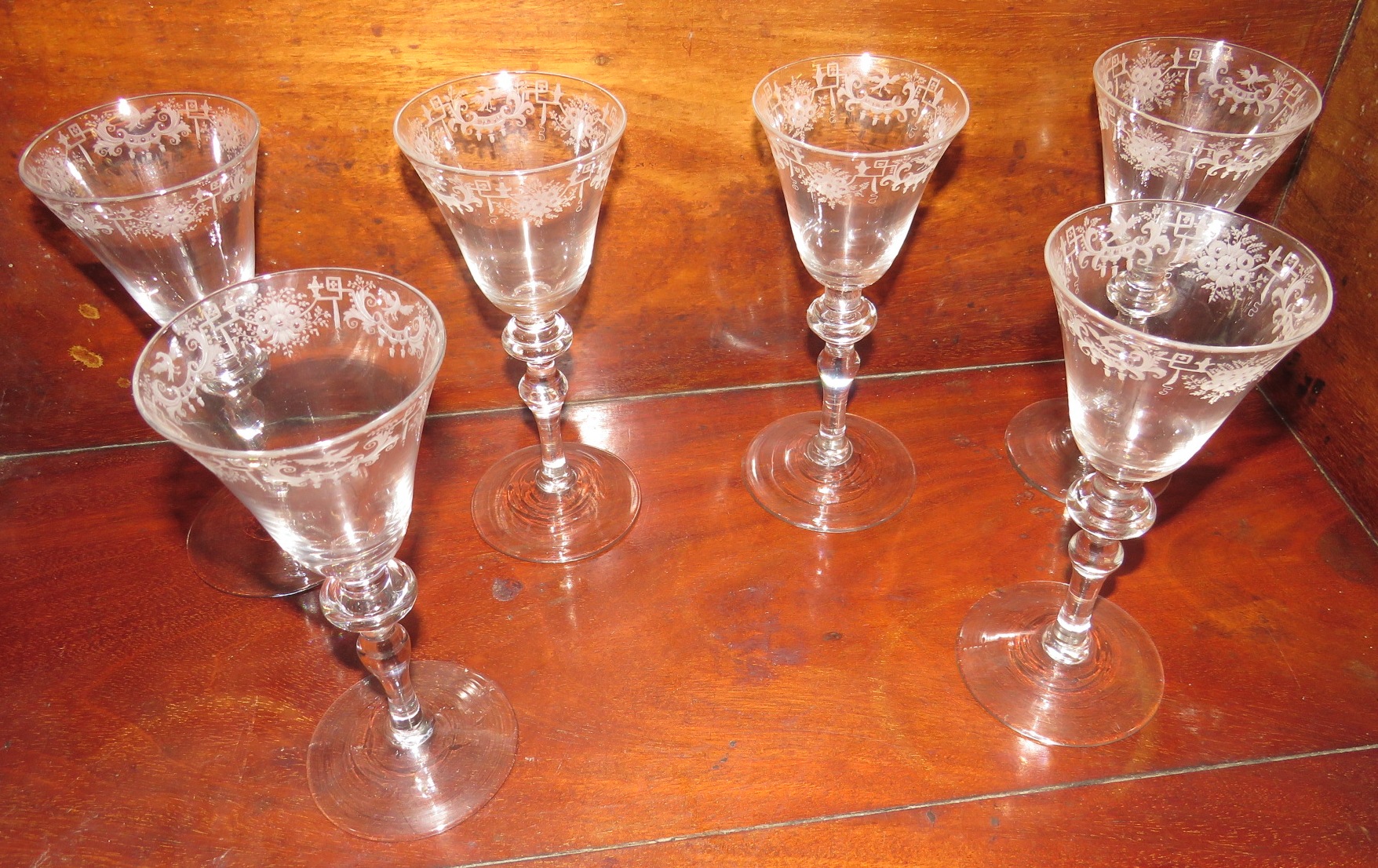 Six goblets with conical bowls etched towards the mouth with a border of geometric lines and