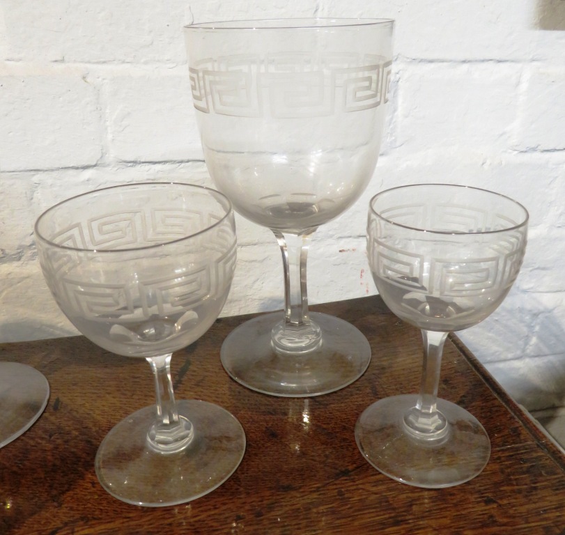 A suite of drinking glasses and a near pair of bottle shape decanters, all etched with key fret - Image 5 of 8