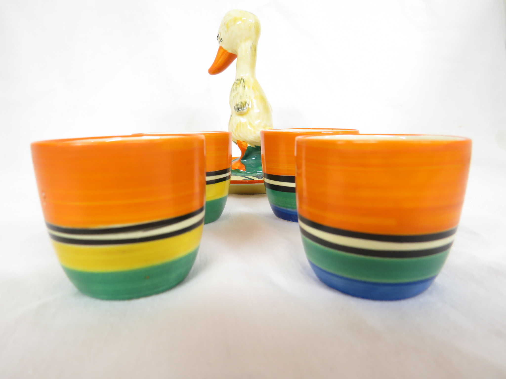 A Clarice Cliff Bizarre duck egg cruet, the stand with an orange border and stylized leaf pattern in - Image 5 of 5