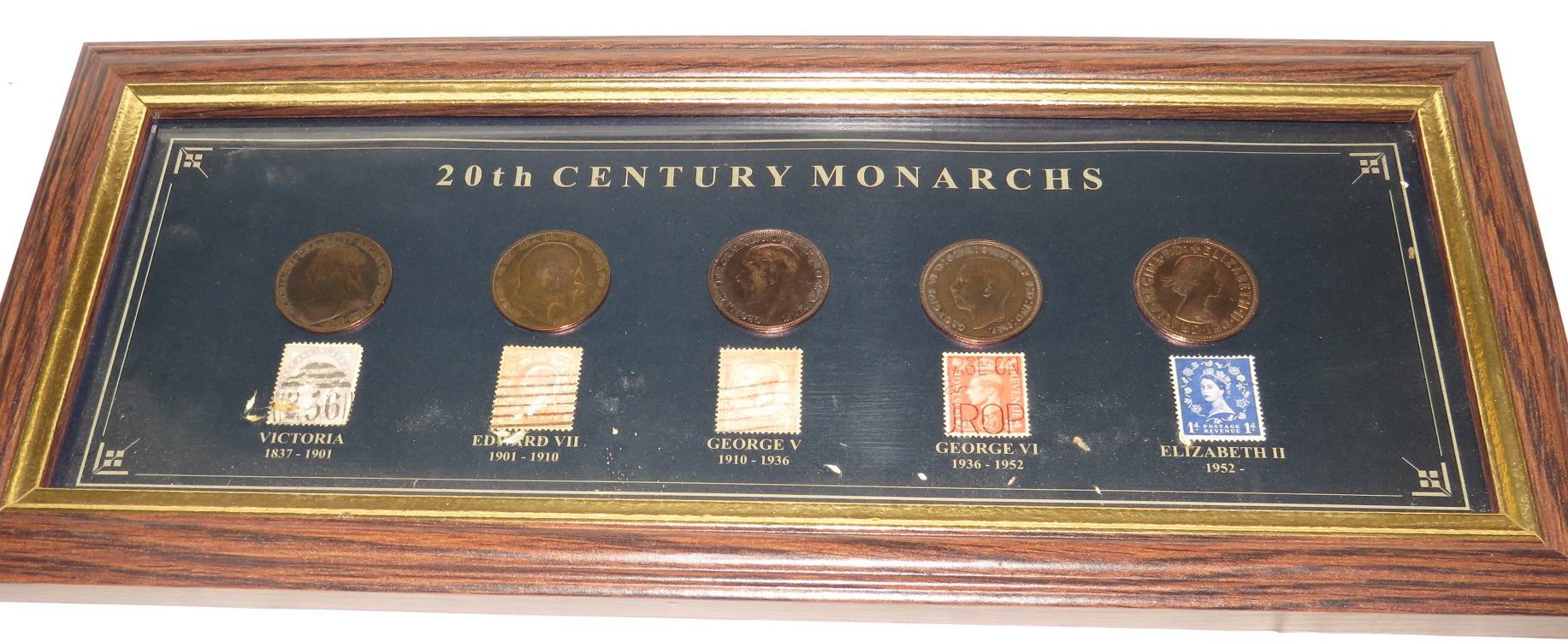 Framed set of five British coins and stamps titled '20th Century Monarchs' (11.5cm x 33.5cm)