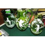 TWO MARY GREGORY GREEN GLASS JUGS WITH PAINTED DECORATIONS DEPICTING BOY AND FAIRY, TOGETHER WITH