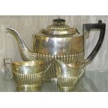 MATCHED SILVER TEA SET COMPRISING OF TEAPOT WITH EBONY HANDLE, MILK JUG AND SUGAR BOWL, HALF REEDED,