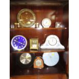 THREE SHELVES OF VINTAGE MANTLE AND DESK CLOCKS AND BAROMETERS