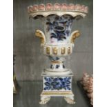 DECORATIVE PORCELAIN URN WITH BASE AND HAND PAINTED GILT DECORATION (A/F)