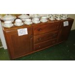 ERCOL MID ELM SIDEBOARD WITH THREE CENTRAL DRAWERS AND DOOR TO EITHER SIDE, ON CASTORS