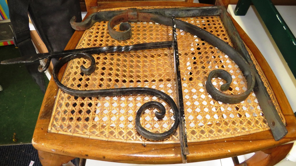 TWO BLACK PAINTED WROUGHT IRON OUTDOOR WALL HANGERS