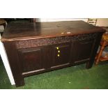 LARGE OAK COFFER WITH CARVING AND PANELLING TO FRONT