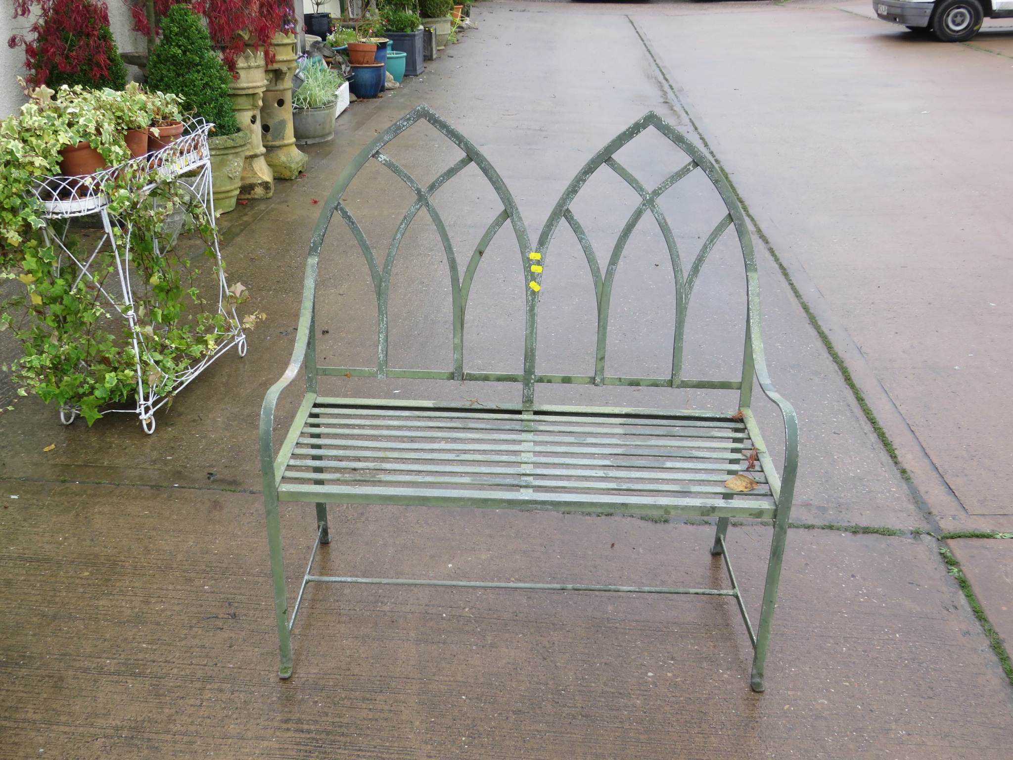 GREEN PAINTED GOTHIC STYLE METAL GARDEN BENCH WITH TWIN ARCH SHAPED BACK