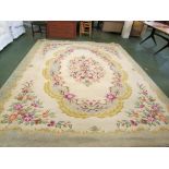LARGE RECTANGULAR CREAM AND GREEN GROUND FLORAL PATTERNED FLOOR RUG WITH TASSELLED ENDS A/F
