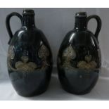 Pair of Royal Doulton stoneware bottles or pitchers of ovoid shape with loop handles at the neck,