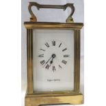 A Mappin & Webb brass cased carriage clock with a plain Roman chapter and reeded corner pilasters