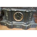 A Victorian black slate Palladian style chiming mantle clock with marble trim. The circular Roman