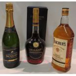 A bottle of Teacher's Highland Cream Blended Scotch Whisky 1 litre, a boxed Courvoisier V.S.O.P.