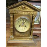 A Victorian striking eight day clock housed in a gilded metal case in the Arabic manner. The