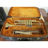 A Corton trumpet serial number 665295 in case with sheet music and music stand