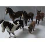 Five Beswick equestrian models - a Dartmoor pony, an Exmoor pony, a brown horse, a black and white