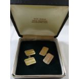 A pair of yellow metal cufflinks, rectangular with engine turned lines, stamped 9ct, combined weight