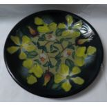 Moorcroft pottery dish, yellow and green ground, dark blue green at edge, decorated with yellow