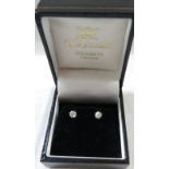 A pair of solitaire diamond ear studs, brilliant cut, each stone estimated at 0.2 carat, white metal