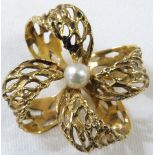 9ct gold pierced work floral brooch set with single pearl to the centre, four looped petals, stamped