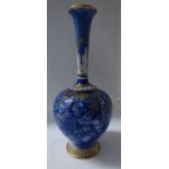 A Royal Worcester porcelain vase of bottle shape with slender neck moulded with acanthus,