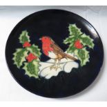 Moorcroft pottery Christmas plate, dark blue with robin, holly and snow, stamped MOORCROFT MADE IN