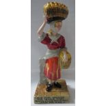 Wilkinson Ltd Clarice Cliff pottery figure of woman street vendor with fruit baskets, the base