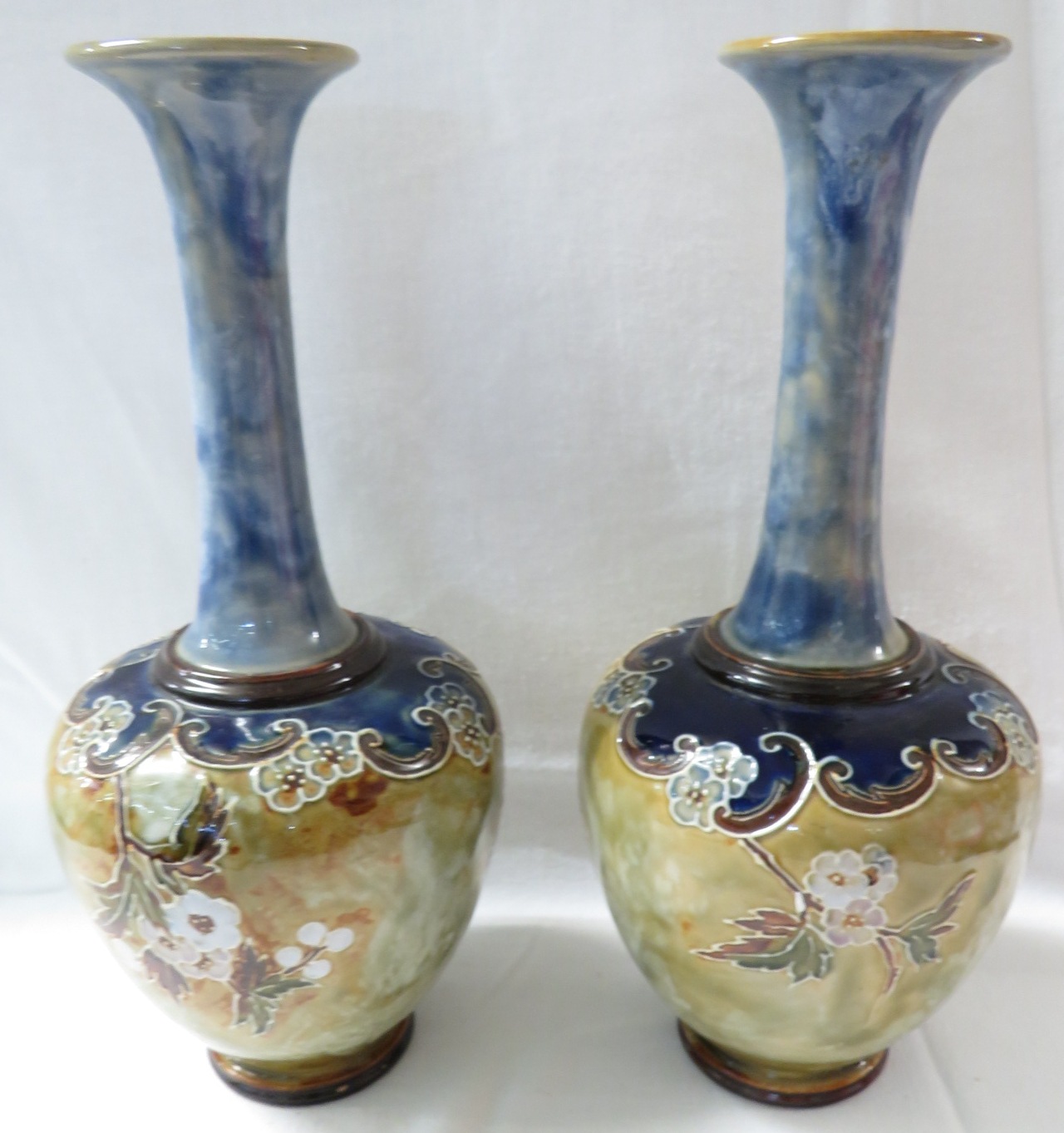 Pair of Royal Doulton bottle vases, pale blue glazed neck, the bodies with tubed line decoration