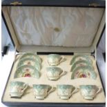 A cased set of six Royal Worcester bone china cups and saucers, decorated in foliate pattern in