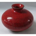 A Ming style terracotta vase or pot of squat form in a bright red mottled glaze falling short of the