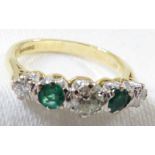 18ct gold ring set with a row of three graduated brilliant cut diamonds spaced by two emeralds,