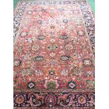 An Iranian carpet with three floral margins, a central reservation with single medallion and