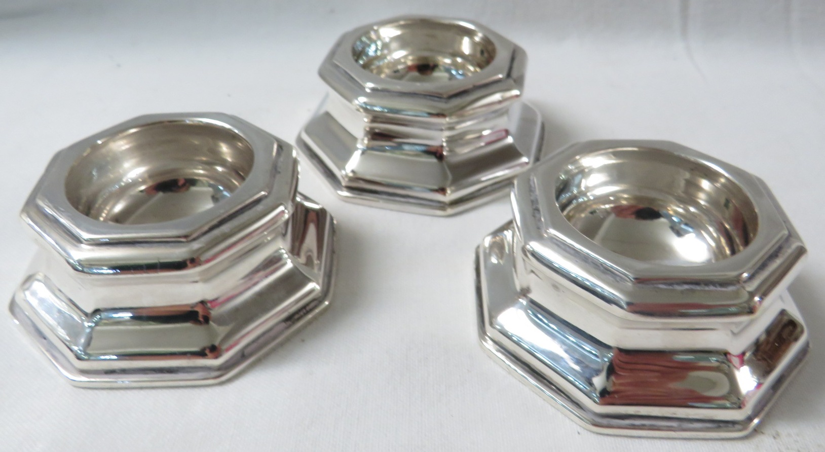 A set of three Goldsmiths & Silversmiths Company Ltd silver salts of octagonal shape, marks for