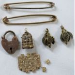 A 9ct gold pin (3.8g), one other metal pin, a heart-shaped lock stamped 18 C.C, a pair of gilt metal